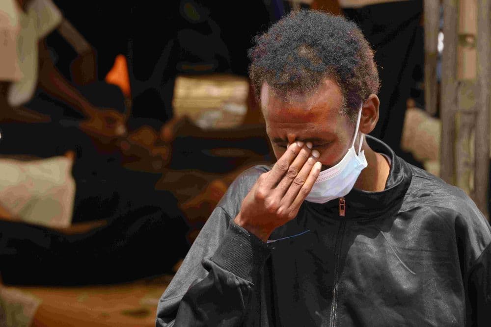 Photo of a person covering their face in a gesture of despair.