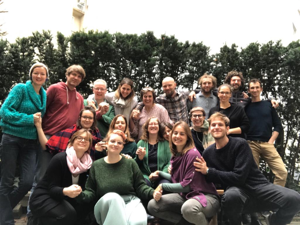 Group of people stand in front of trees