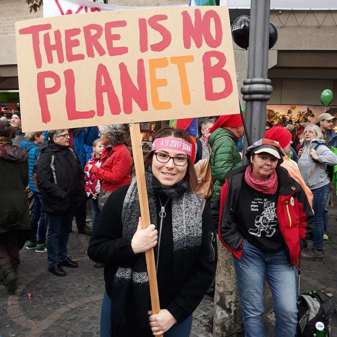 Protesters with sign saying there is no Planet B